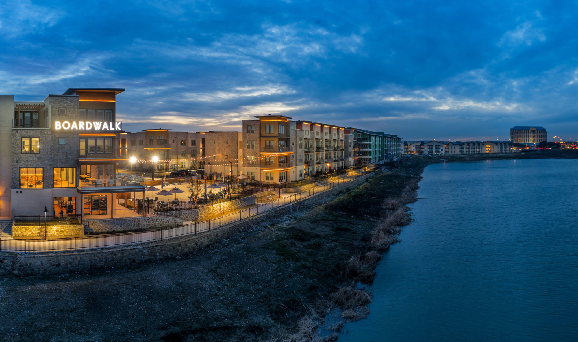 night shot of propety buildings overlooking the lake